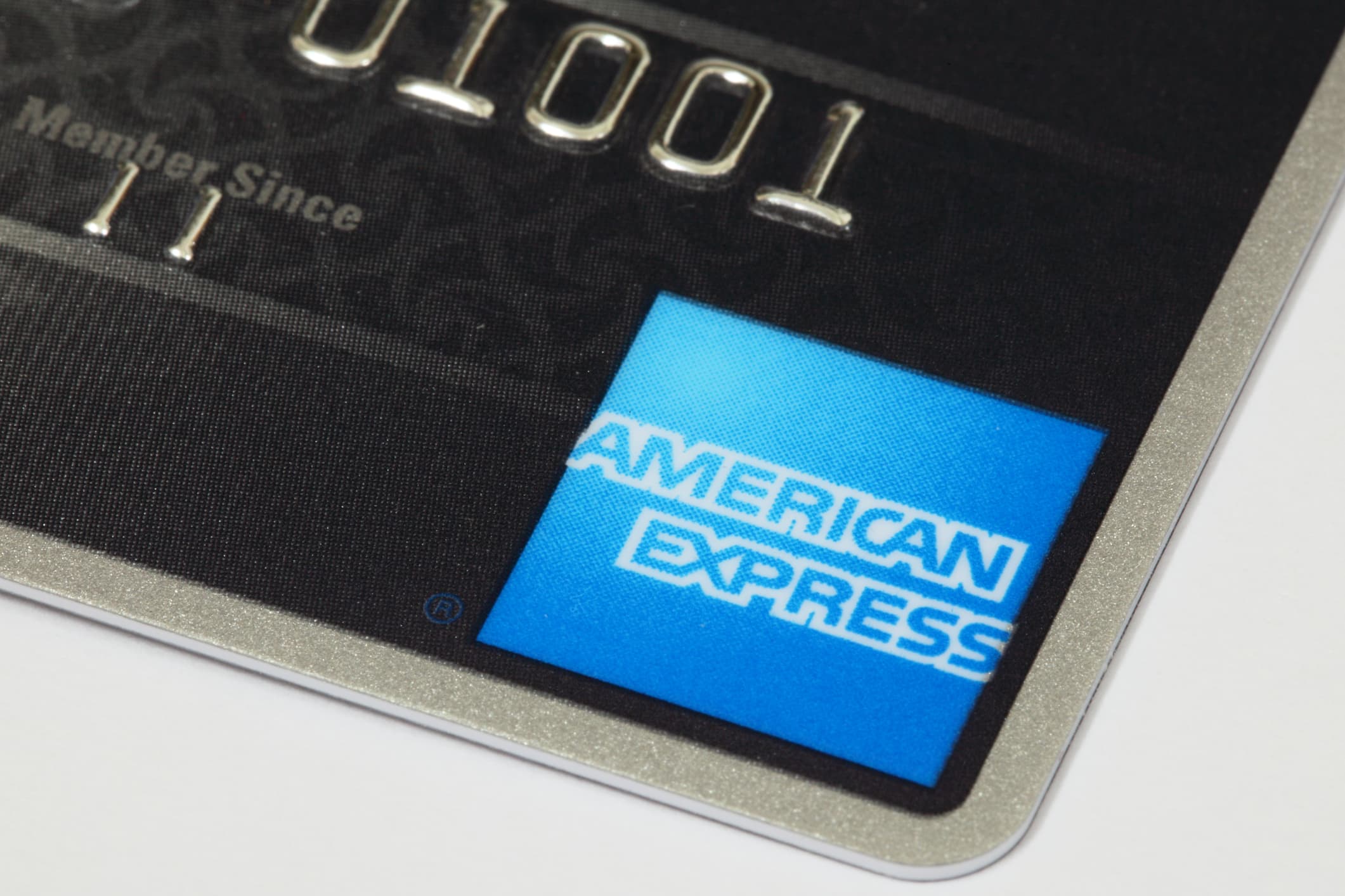 Close-up of a Blue Cash Preferred American Express credit card, highlighting the iconic blue logo on a metallic background.