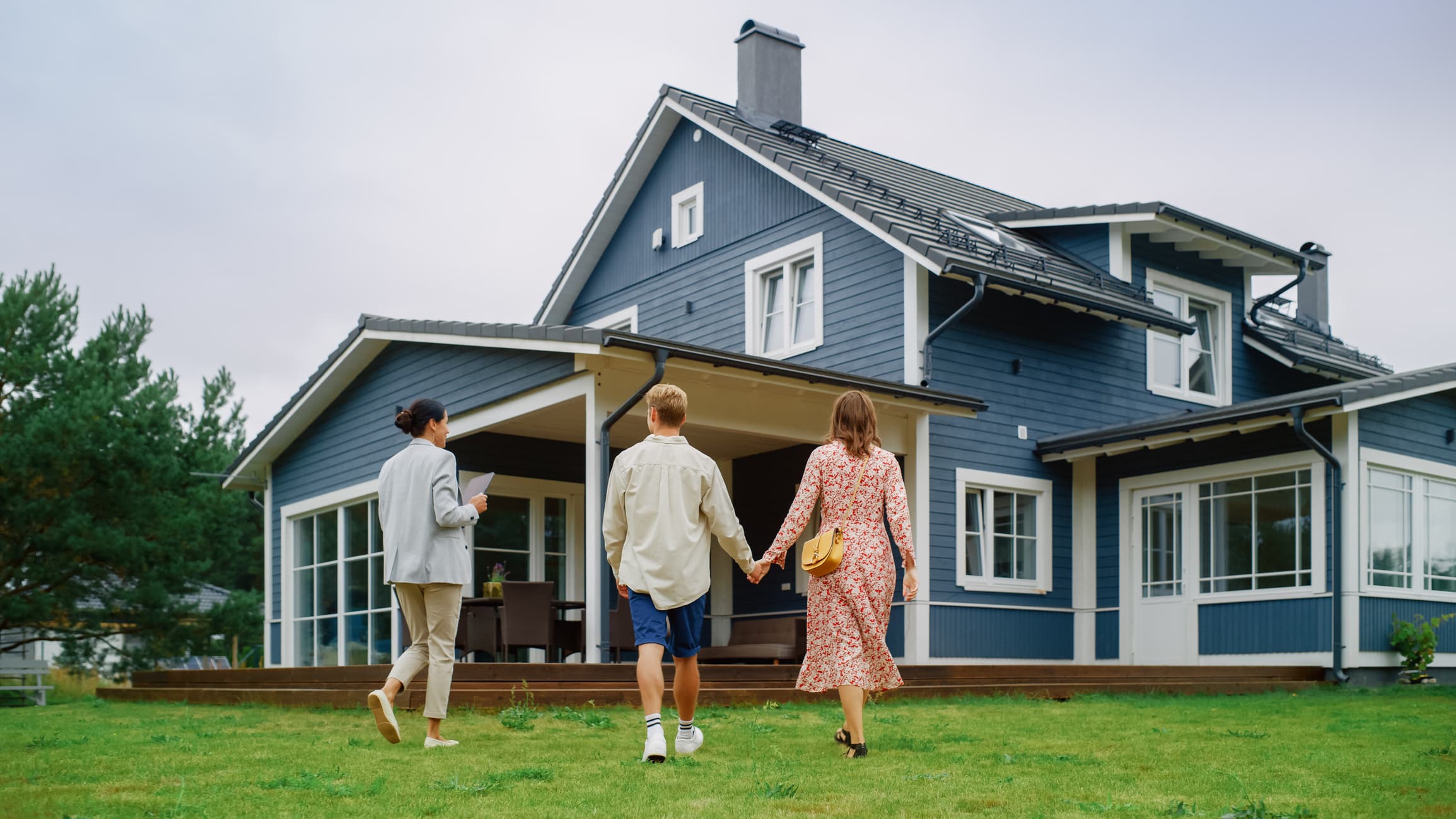 Couple touring a home with a real estate agent—ideal visual for articles comparing the best mortgage lenders.