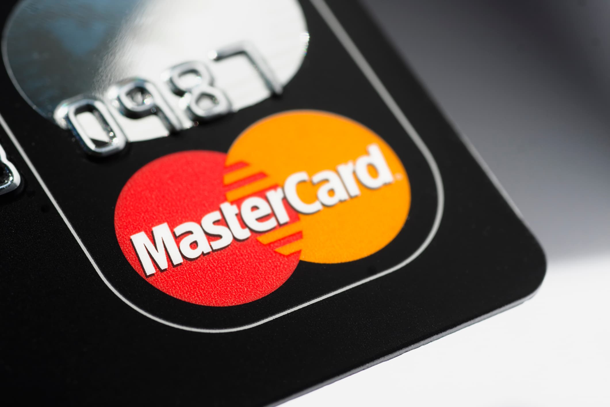Close-up of an embossed black Mastercard with the iconic red and yellow logo, symbolizing Indigo Mastercard reviews.