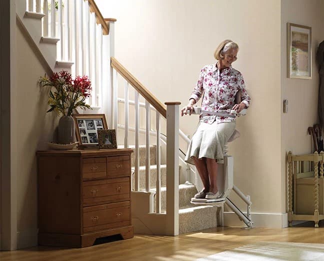 Top 6 Best Stairlifts For Seniors — Stannah-Sadler-Standing.jpg