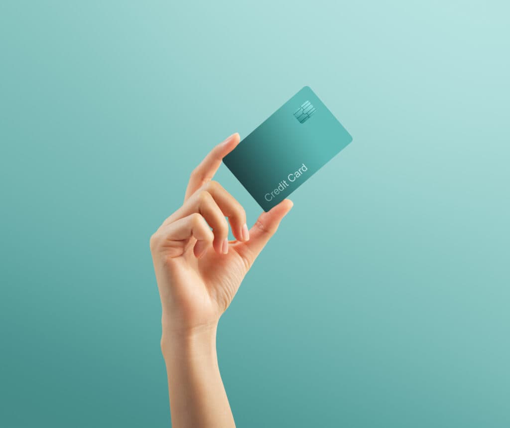 Mission Lane credit card reviews feature image of credit card in a hand