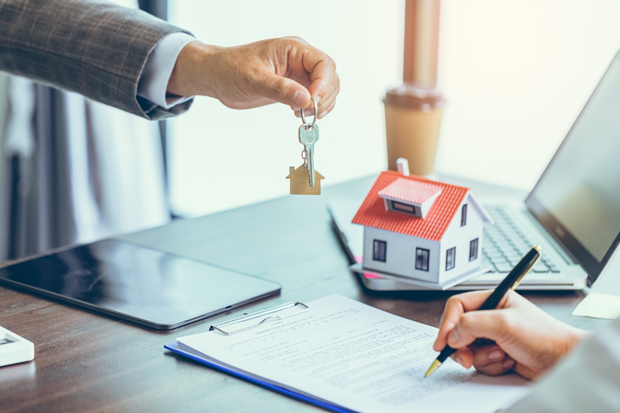 Real estate closing with house keys, contract, and miniature home—ideal image for Chase Mortgage reviews content.