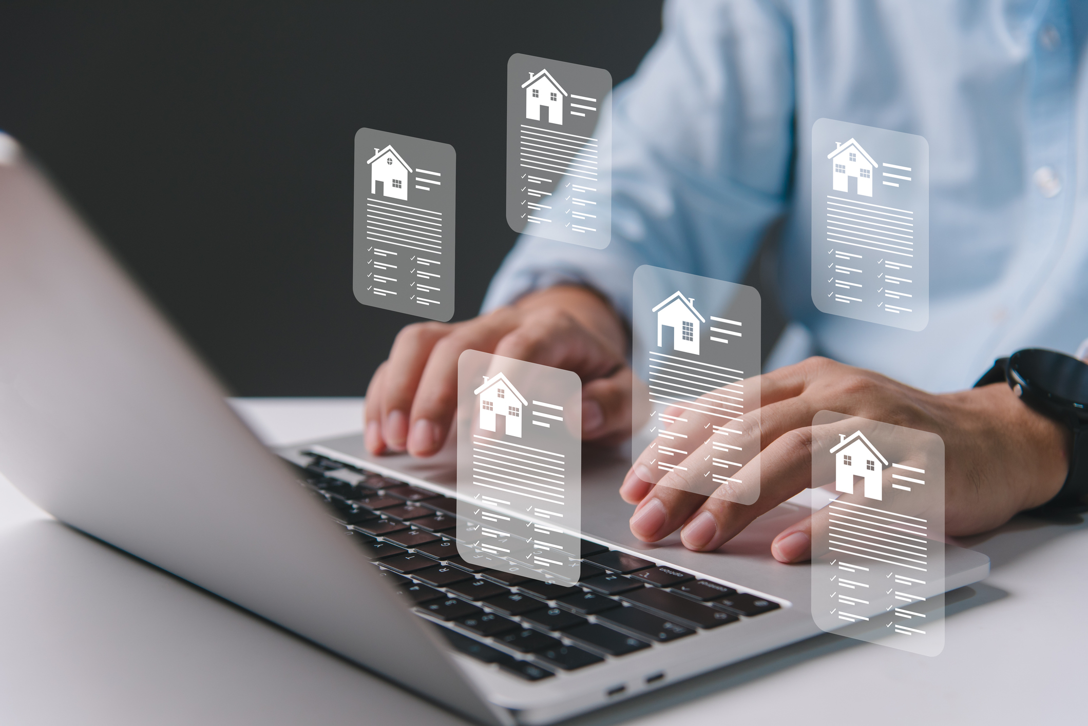 A person types on a laptop with digital home loan documents floating above the keyboard — perfect for illustrating a Credible home loans review.