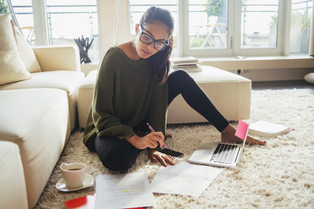 Person reviewing financial documents and planning strategic financial resolutions at home