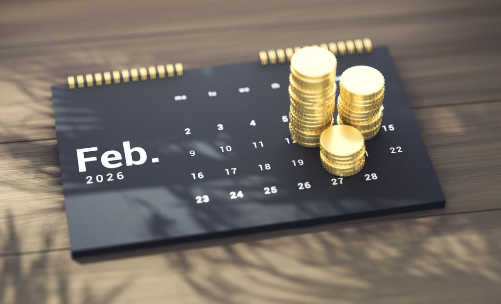 February market analysis concept image showing a February 2026 calendar with stacked gold coins representing financial trends and market movement.