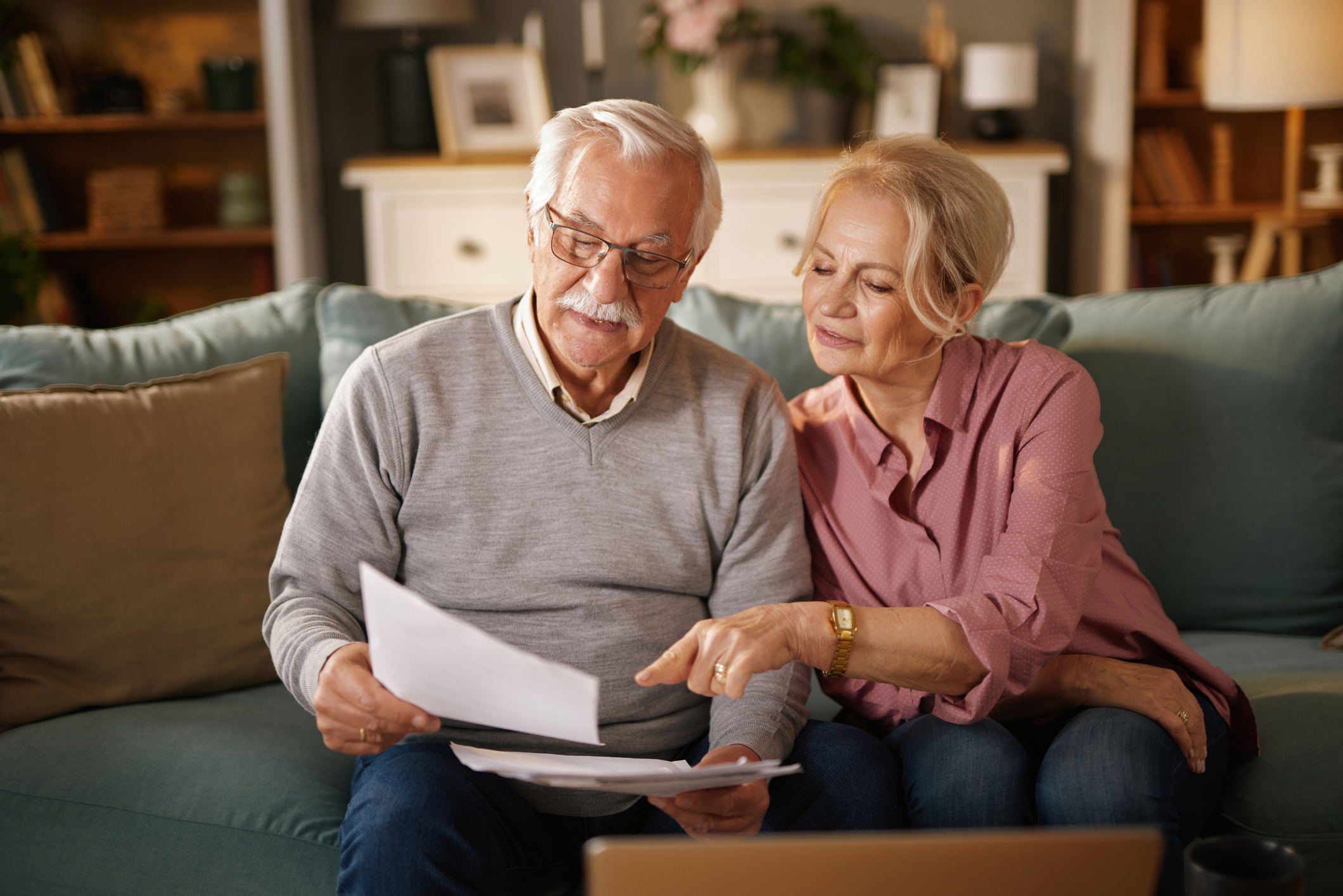 Senior couple reviewing documents at home for best life insurance for seniors