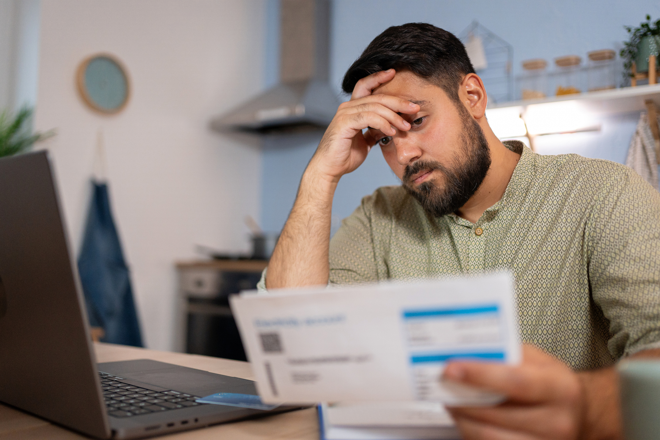 Man reviewing bills and debt consolidation options for bad credit at home